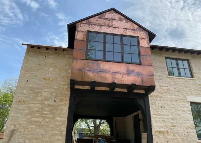 Copper metal panel facade on a stone building for Metal Roof Coating in Robinson